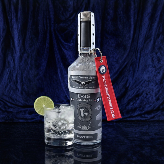 Photo of Special Tribute Spirits' F-35 decanter next to a patriotic liquor pourout with ice and lime; excellent Air Force veteran gifts for F 35 pilots.